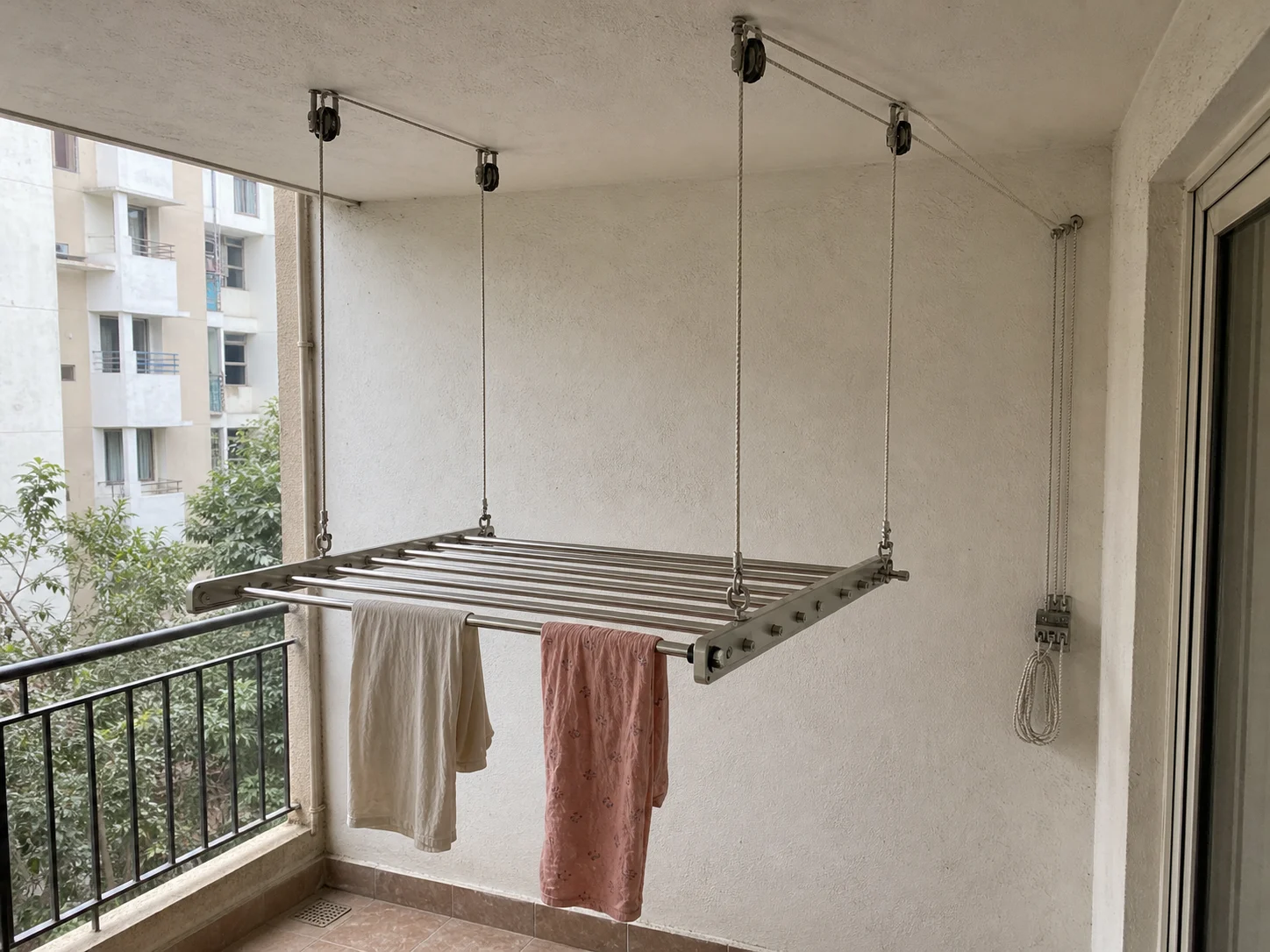 Close view of a ceiling cloth hanger with lift cords and wall control rope